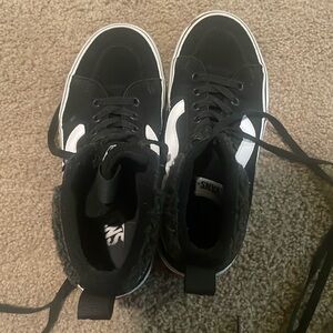 Black and white high top Vans